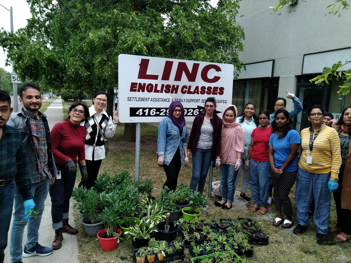 Staff and students with plants in front of SAFSS Finch Centre office.